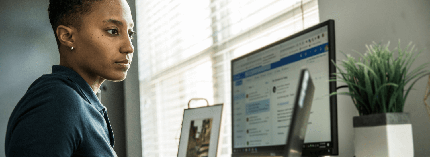 Woman at home sitting at desk with computer